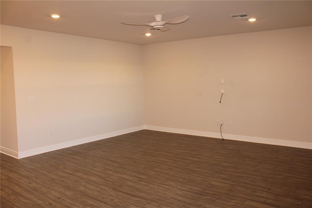 8232 Reefbay Cove Parrish, FL 34221 - Photo 13 of 64 an empty room with wooden floor and fan
