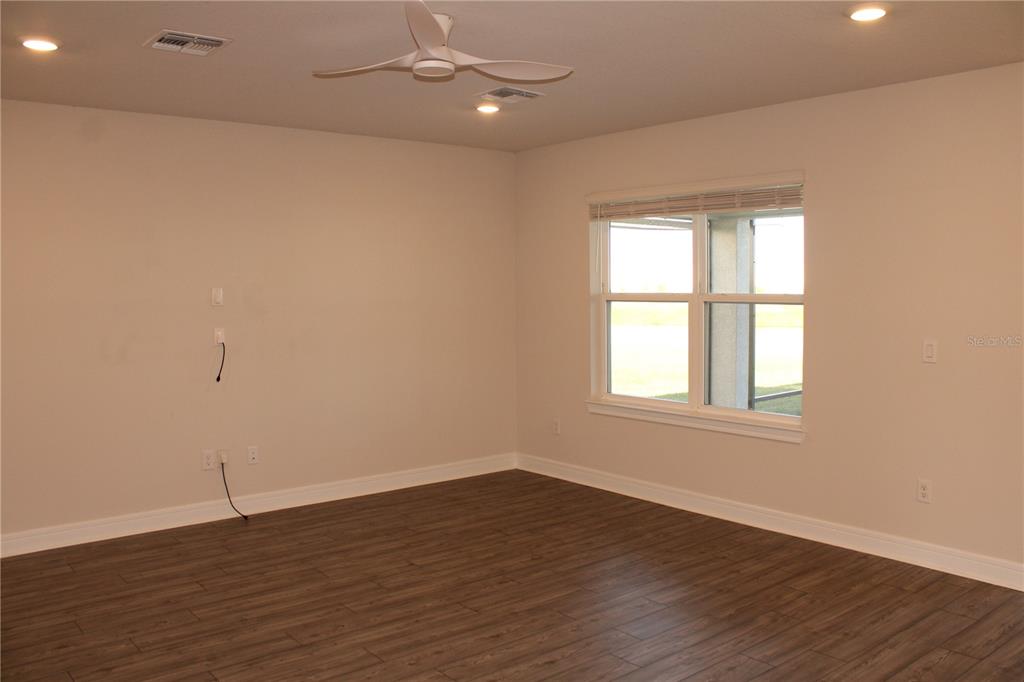 8232 Reefbay Cove Parrish, FL 34221 - Photo 14 of 64 an empty room with wooden floor and windows