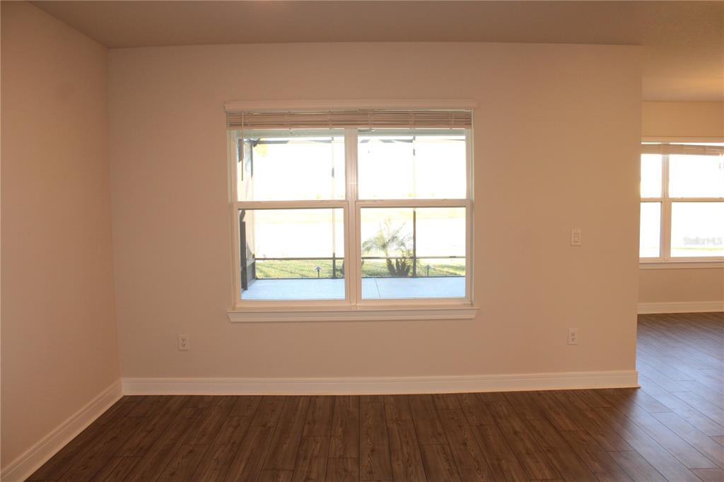 8232 Reefbay Cove Parrish, FL 34221 - Photo 15 of 64 an empty room with wooden floor and windows