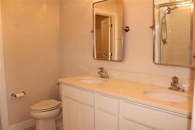 a bathroom with a shower a toilet and a bath tub