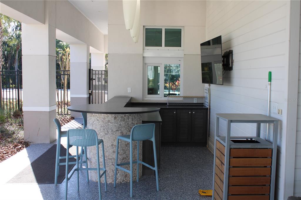 8232 Reefbay Cove Parrish, FL 34221 - Photo 58 of 64 a kitchen with a sink cabinets and wooden floor