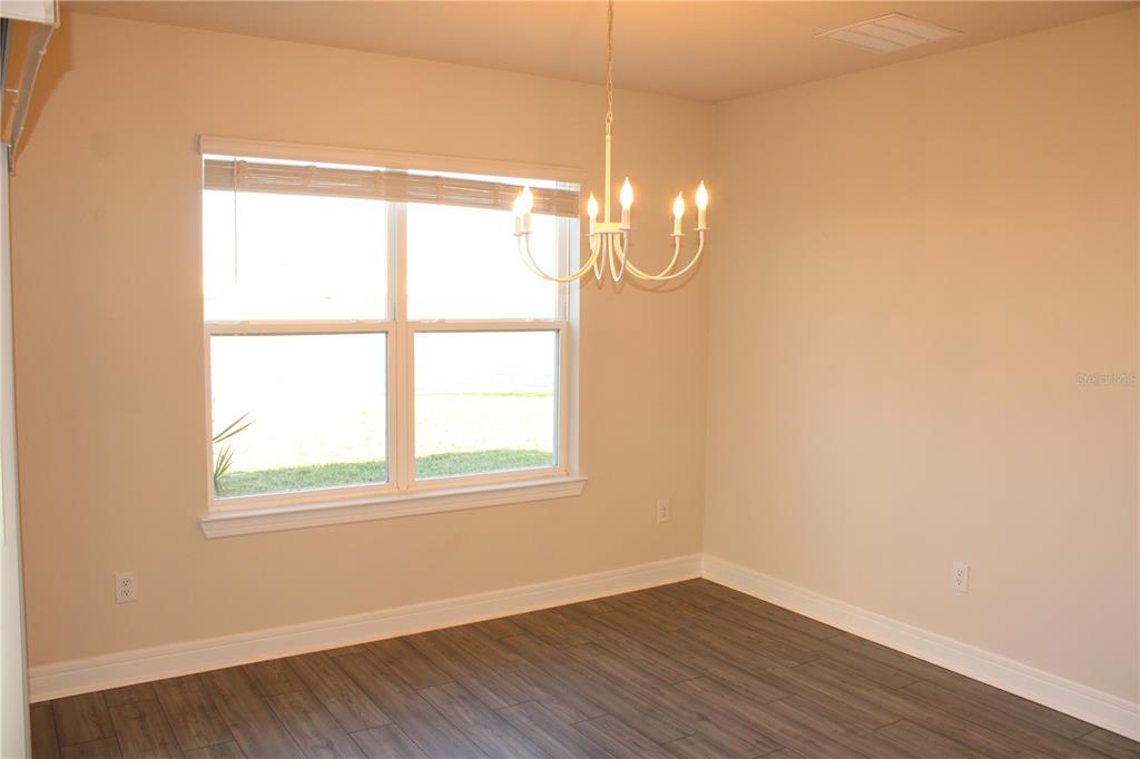 8232 Reefbay Cove Parrish, FL 34221 - Photo 9 of 64 an empty room with wooden floor and windows