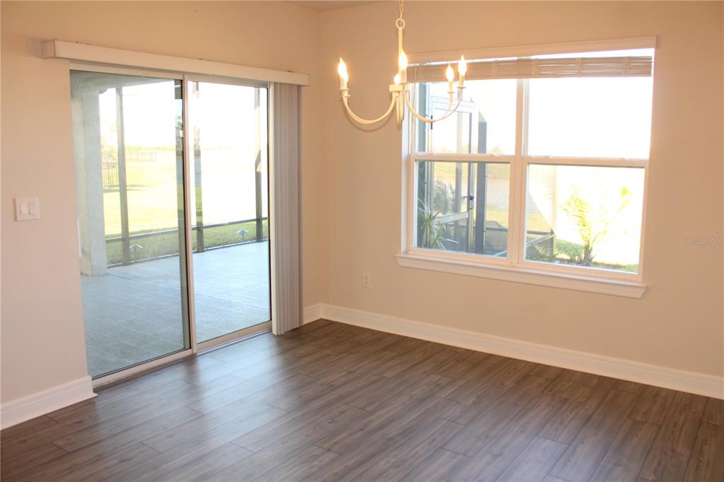 8232 Reefbay Cove Parrish, FL 34221 - Photo 10 of 64 an empty room with wooden floor and windows