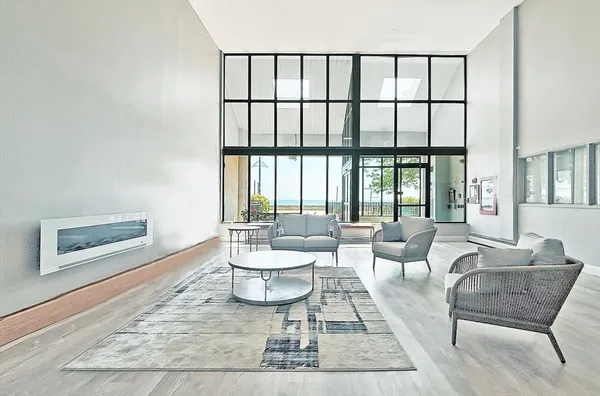 a living room with furniture and a floor to ceiling window