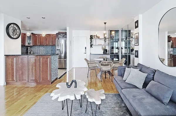 a living room with furniture and wooden floor