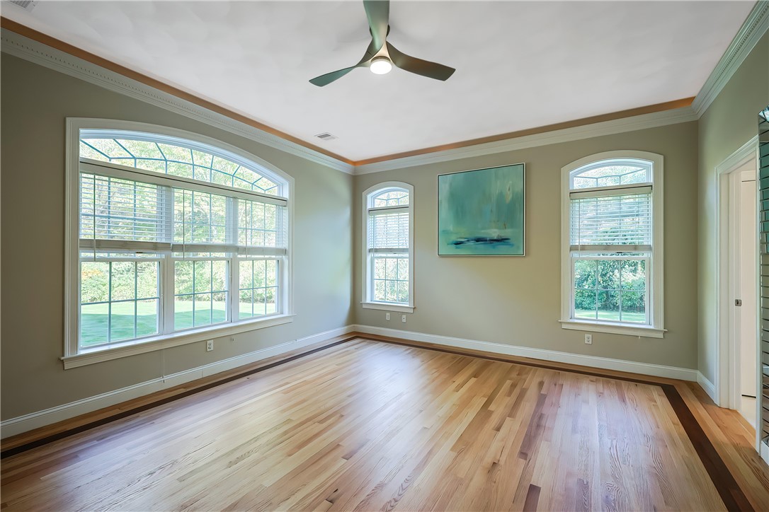 321 Greenville Road North Smithfield, RI 02896 - Photo 21 of 50 Triple crown molding and arched windows give that primary bedroom feeling