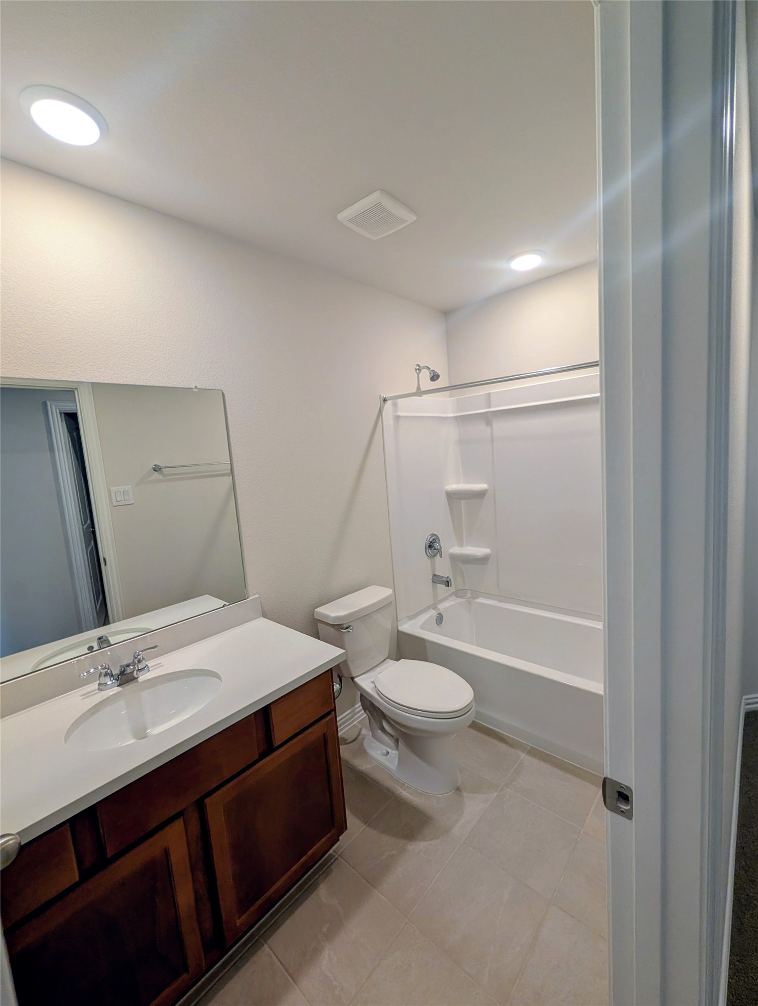 32314 Mimosa Ridge Lane Waller, TX 77484 - Photo 9 of 16 a bathroom with a double vanity sink toilet mirror and bathtub