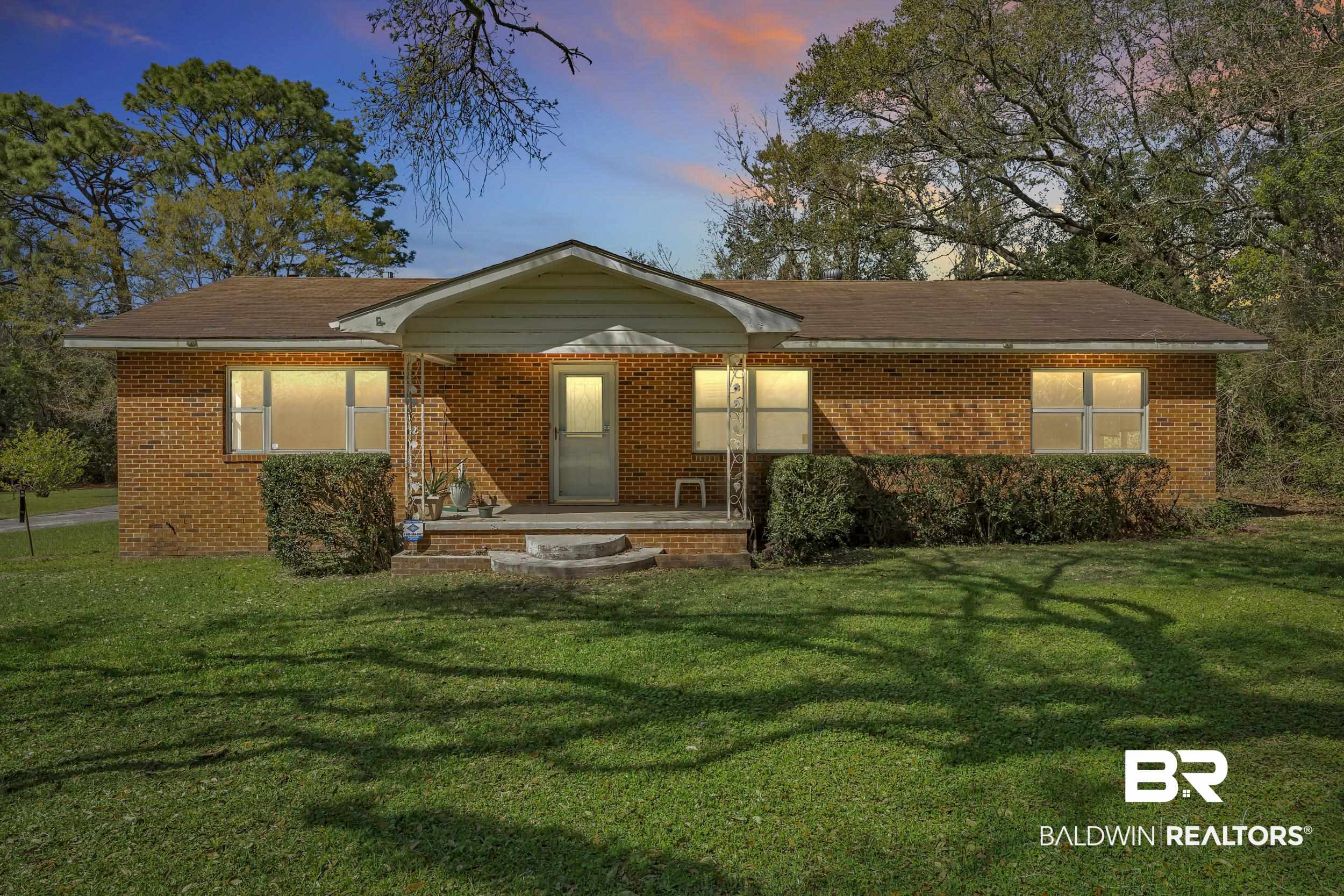 17463 Highway 98 Foley, AL 36535 - Photo 1 of 57 View of front of house with brick siding, a front lawn, and a porch