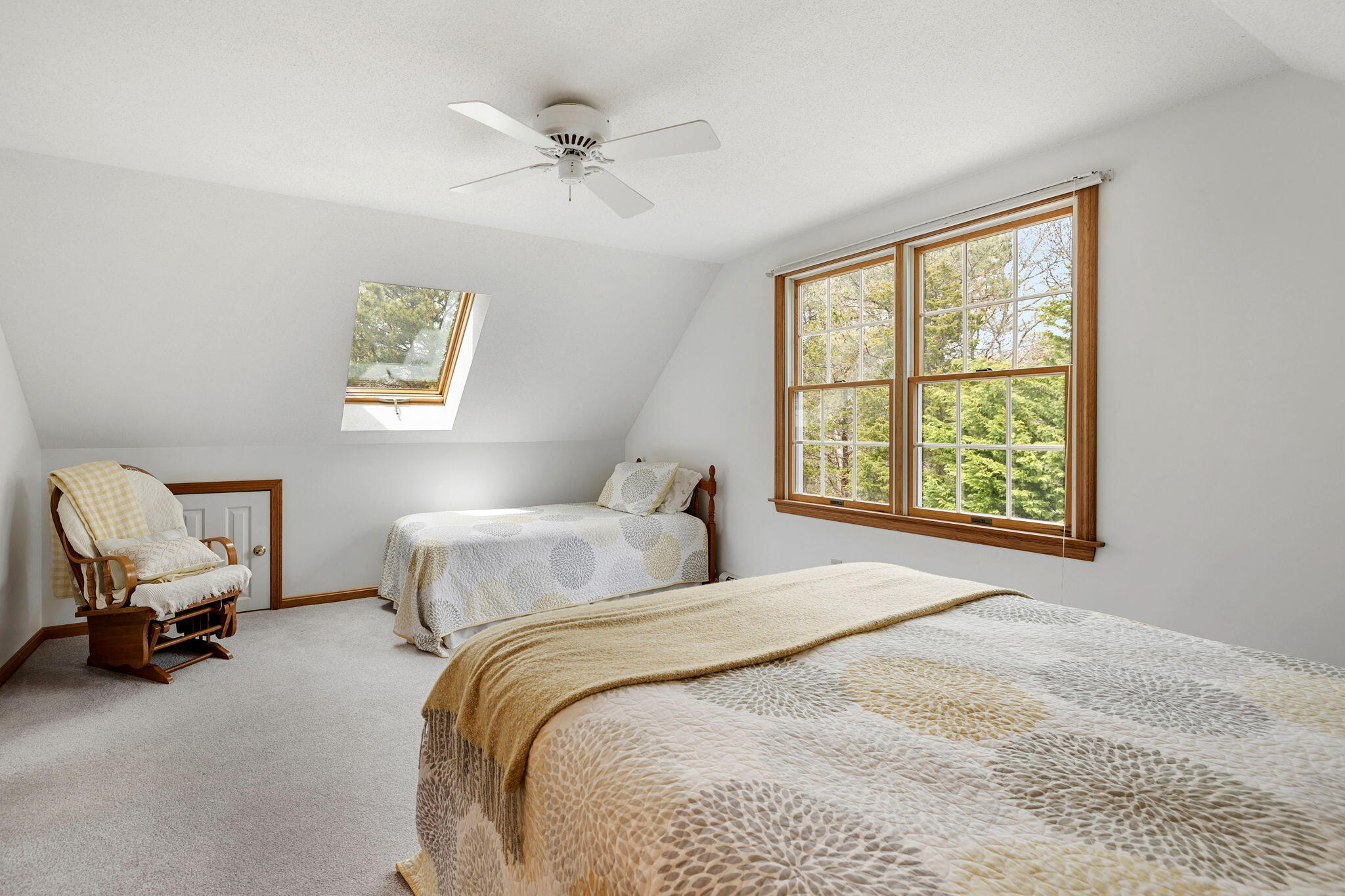 9 Raymond Way Eastham, MA 02642 - Photo 21 of 27 a bedroom with a bed a chandelier and a window