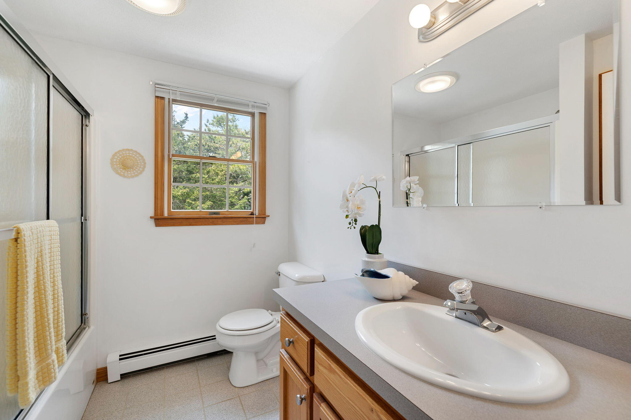 9 Raymond Way Eastham, MA 02642 - Photo 22 of 27 a bathroom with a toilet a sink and a mirror