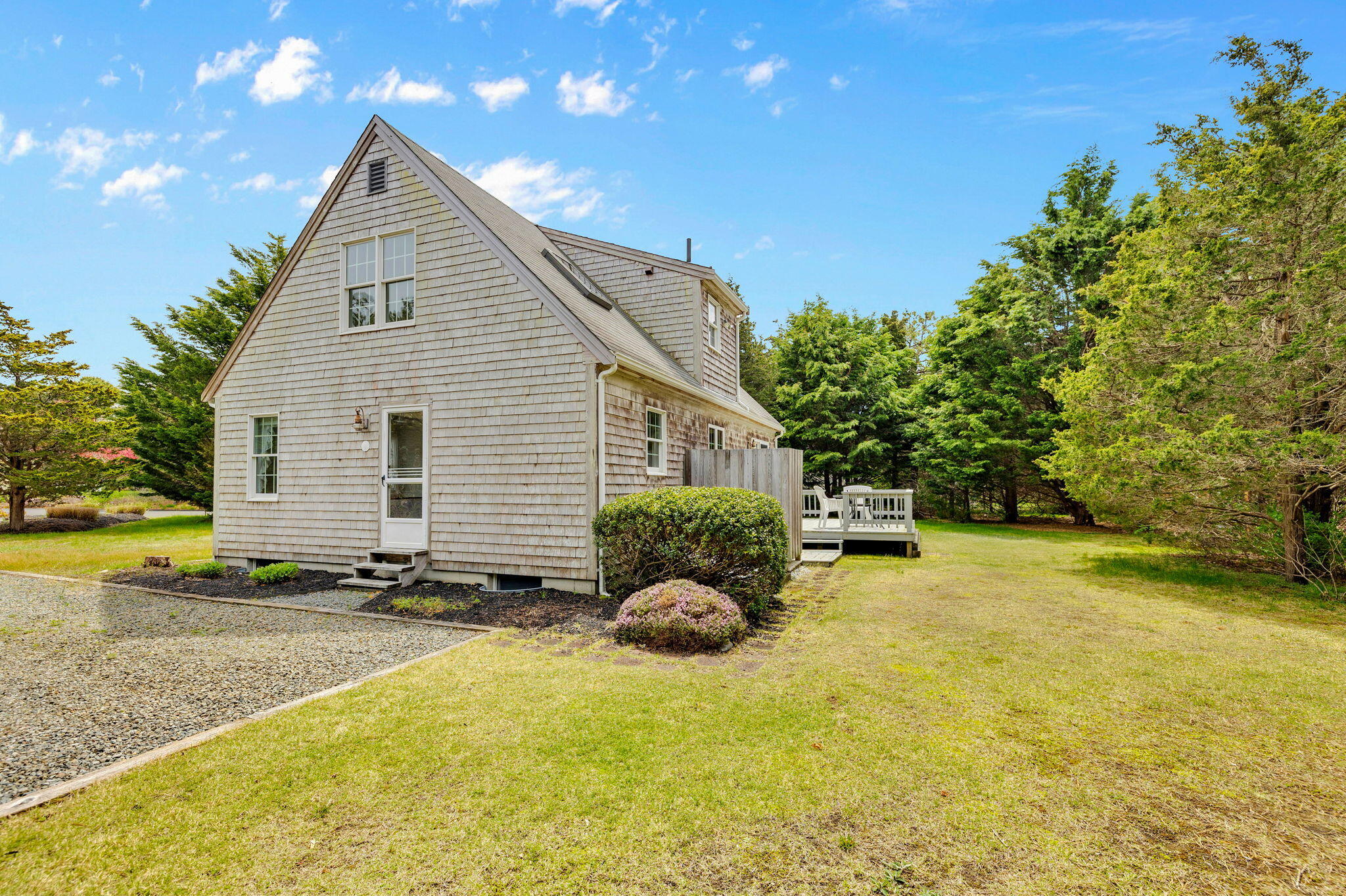 9 Raymond Way Eastham, MA 02642 - Photo 24 of 27 a backyard of a house with yard and outdoor seating
