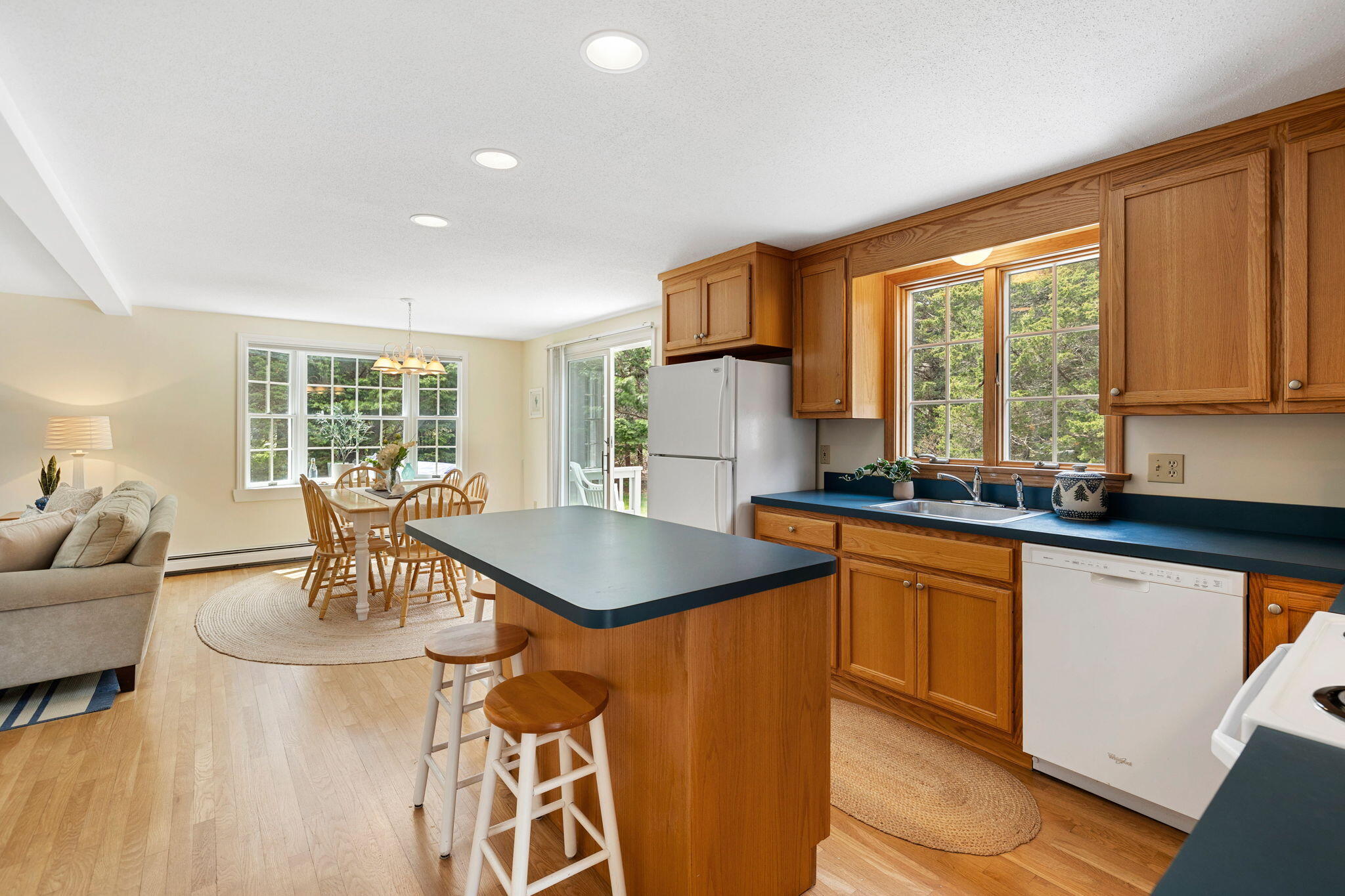 9 Raymond Way Eastham, MA 02642 - Photo 8 of 27 a kitchen with a table chairs sink and wooden floor