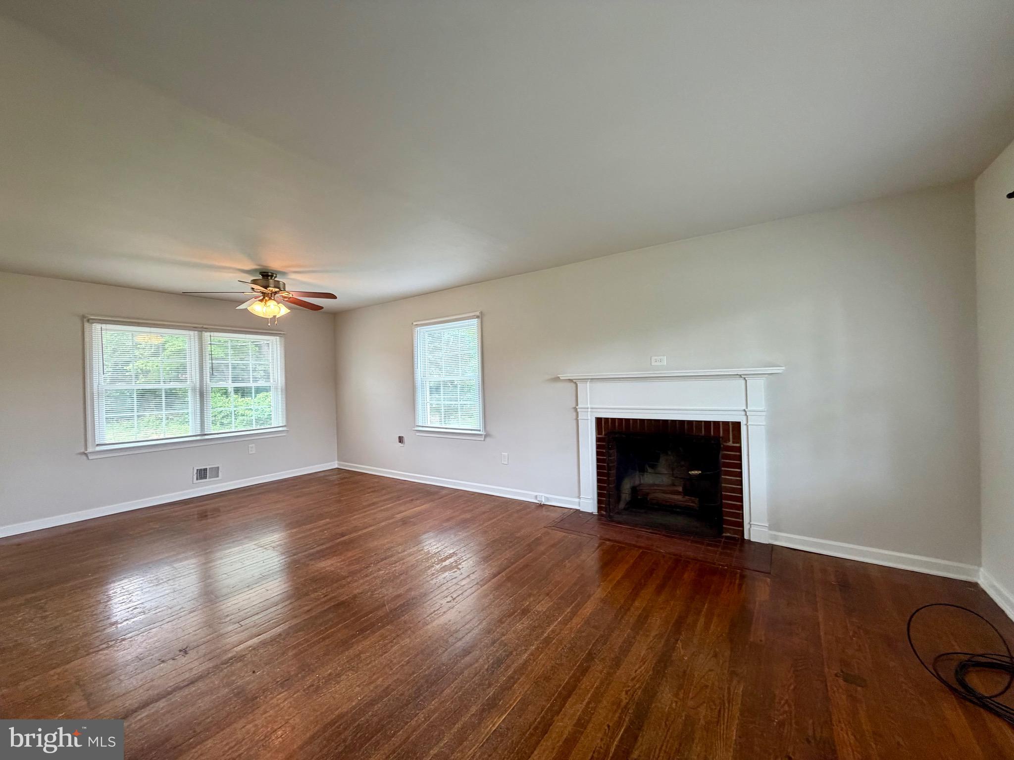 1010 Nottingham Street Culpeper, VA 22701 - Photo 12 of 21 an empty room with wooden floor fireplace and windows