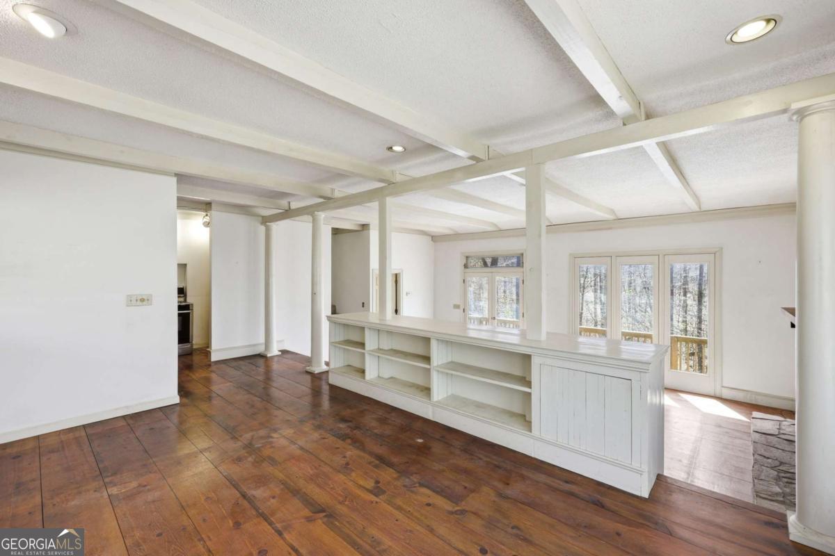 508 Providence Road Statham, GA 30666 - Photo 11 of 39 a large white kitchen with white cabinets and wooden floor
