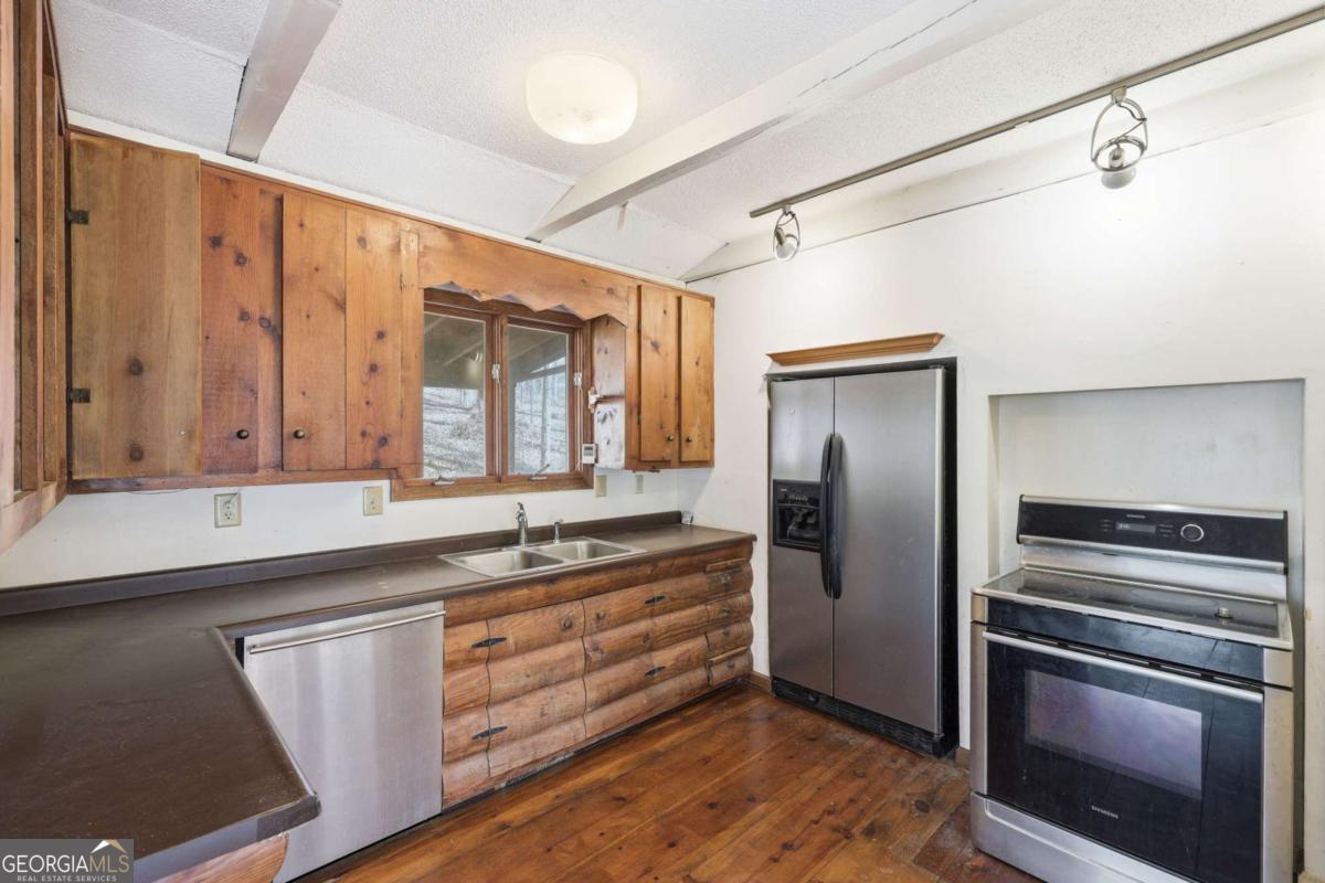 508 Providence Road Statham, GA 30666 - Photo 12 of 39 a kitchen with a refrigerator and a sink