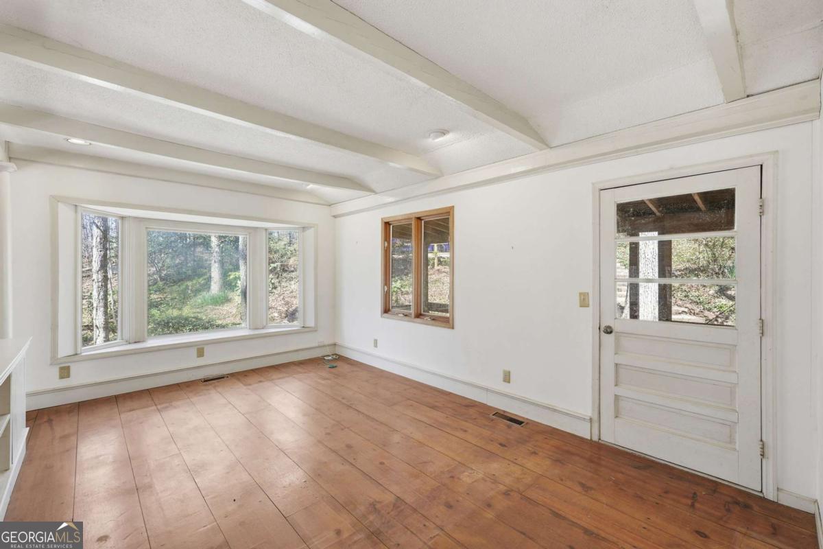 508 Providence Road Statham, GA 30666 - Photo 13 of 39 a view of an empty room with wooden floor and a window