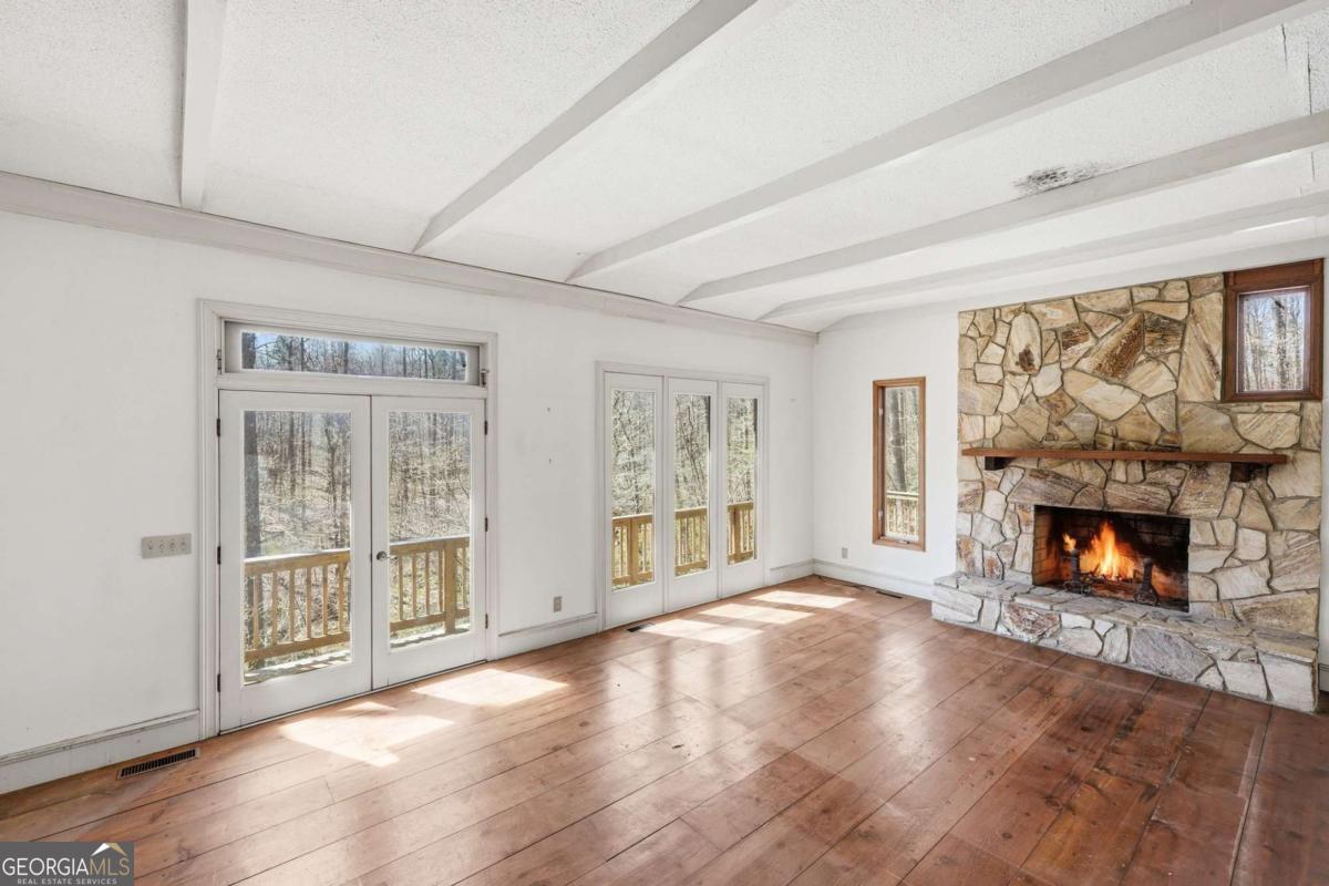 508 Providence Road Statham, GA 30666 - Photo 14 of 39 an empty room with furniture and a fireplace
