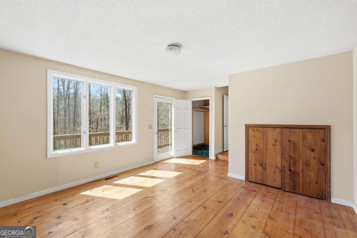 508 Providence Road Statham, GA 30666 - Photo 20 of 39 a view of an empty room with wooden floor and a window