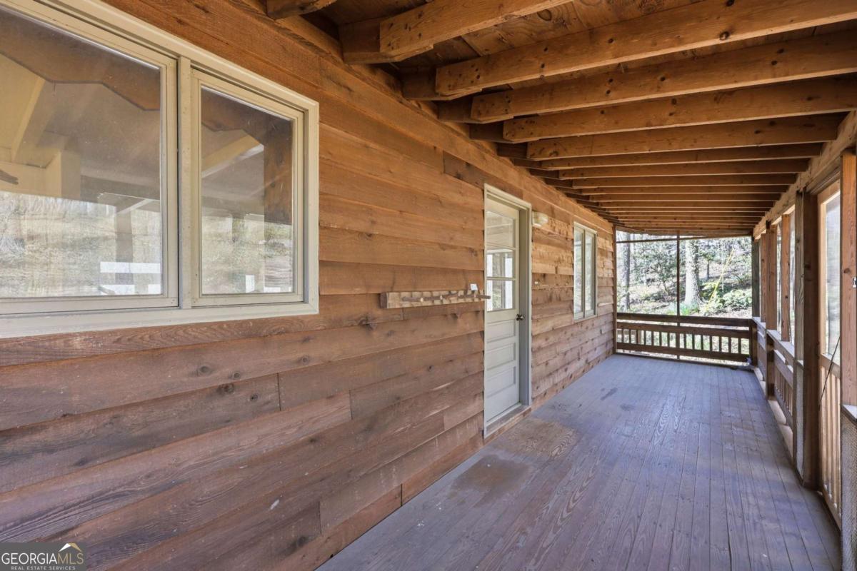 508 Providence Road Statham, GA 30666 - Photo 2 of 39 a view of an empty room with wooden floor and a window