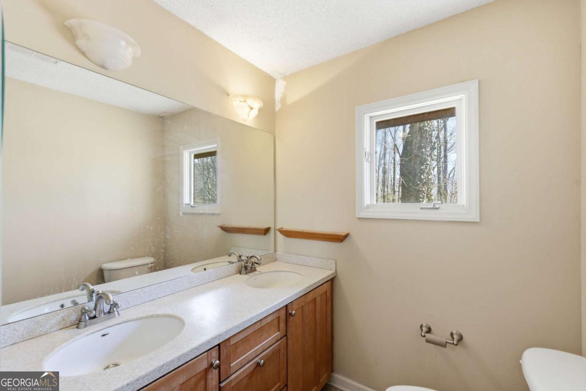 508 Providence Road Statham, GA 30666 - Photo 26 of 39 a bathroom with a granite countertop sink mirror and toilet