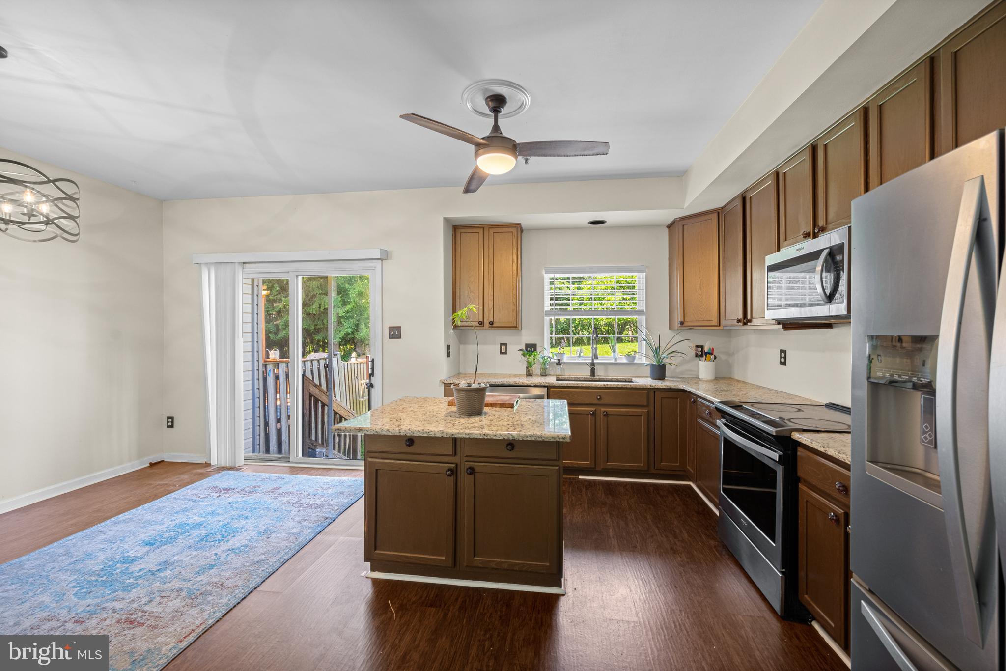 9837 Sherwood Farm Road Owings Mills, MD 21117 - Photo 11 of 35 a kitchen with stainless steel appliances granite countertop a sink stove and refrigerator