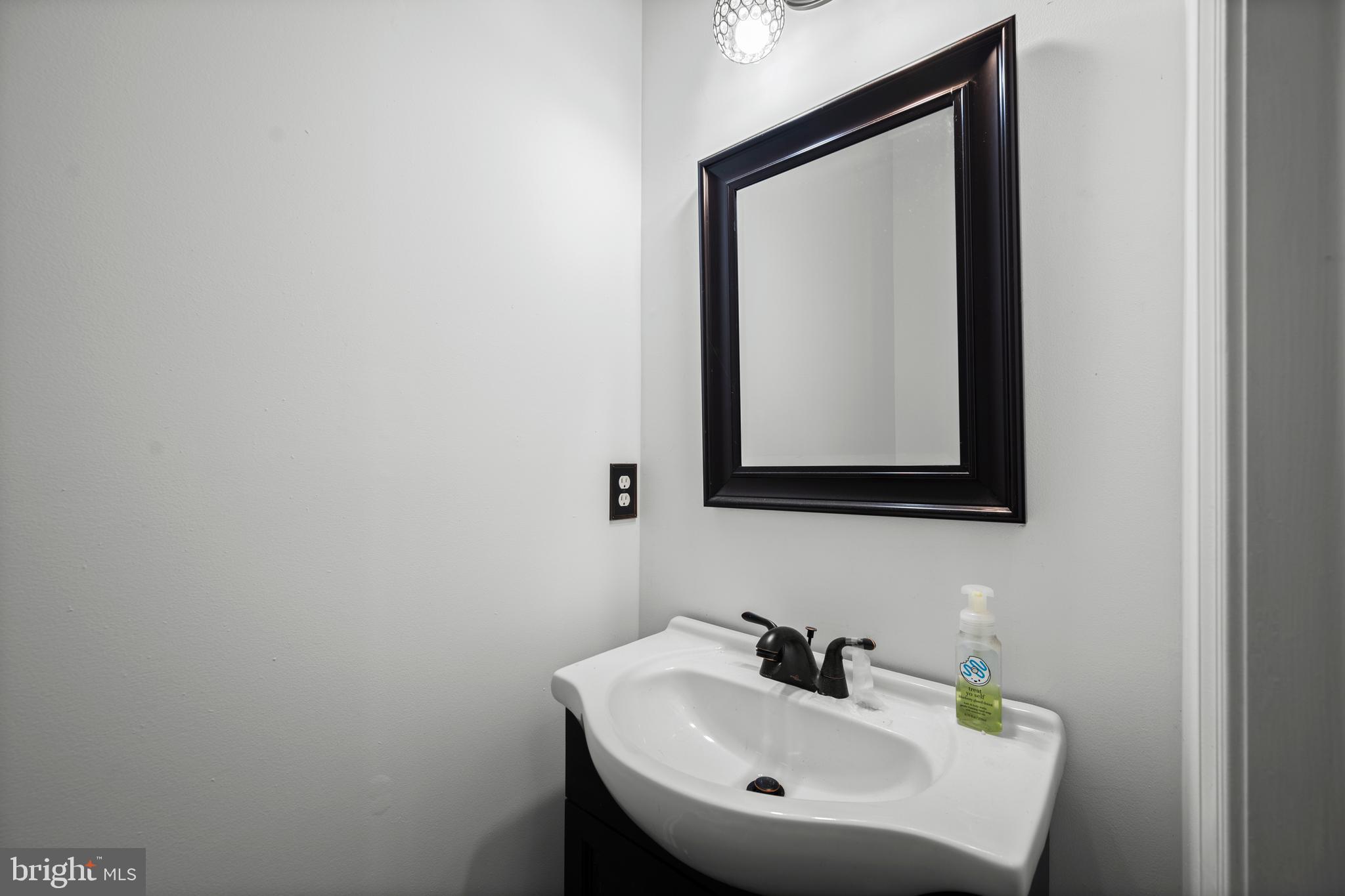 9837 Sherwood Farm Road Owings Mills, MD 21117 - Photo 14 of 35 a bathroom with a sink and a mirror