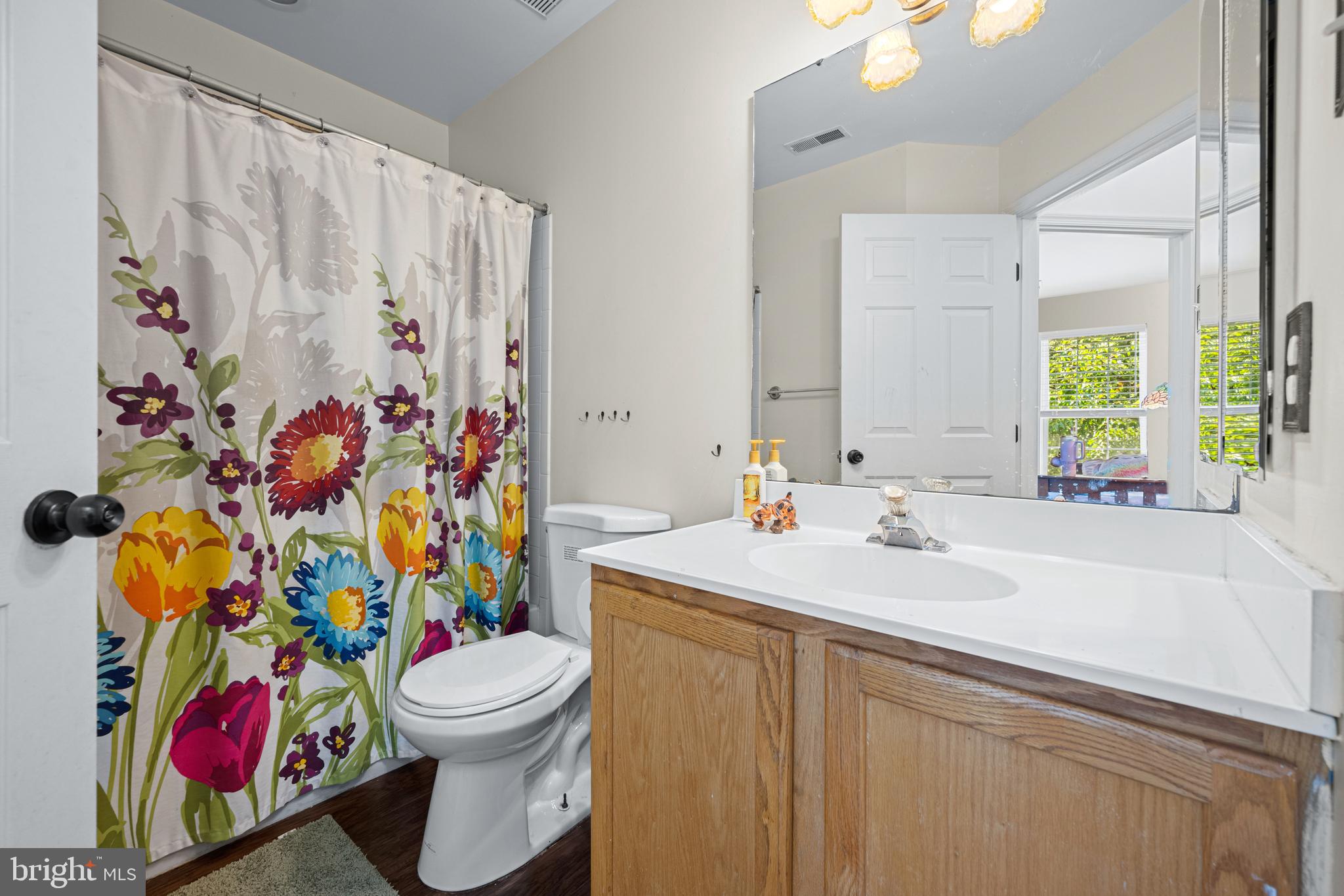 9837 Sherwood Farm Road Owings Mills, MD 21117 - Photo 19 of 35 a bathroom with a sink mirror vanity and toilet