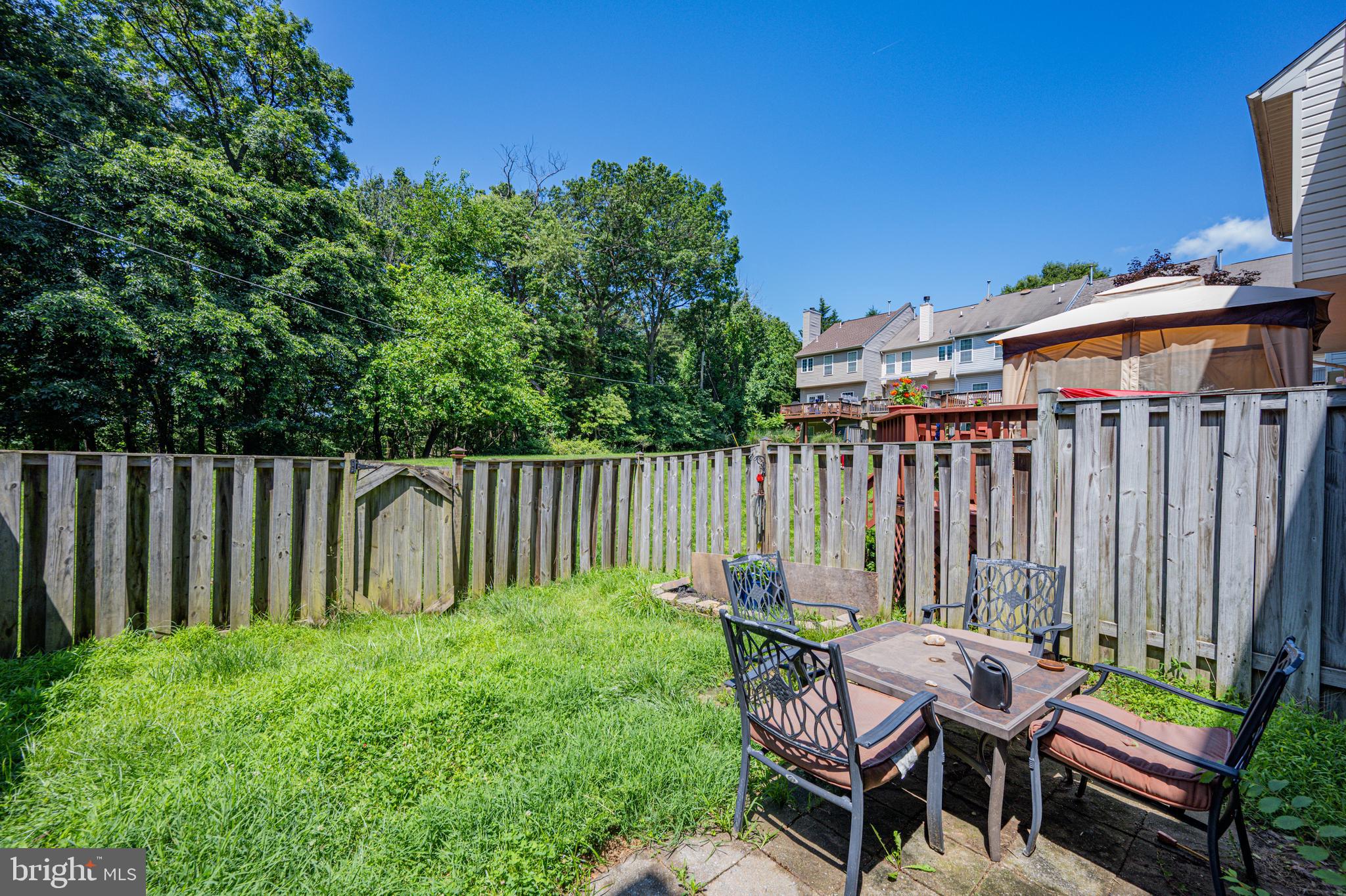 9837 Sherwood Farm Road Owings Mills, MD 21117 - Photo 30 of 35 a backyard of a house with table and chairs