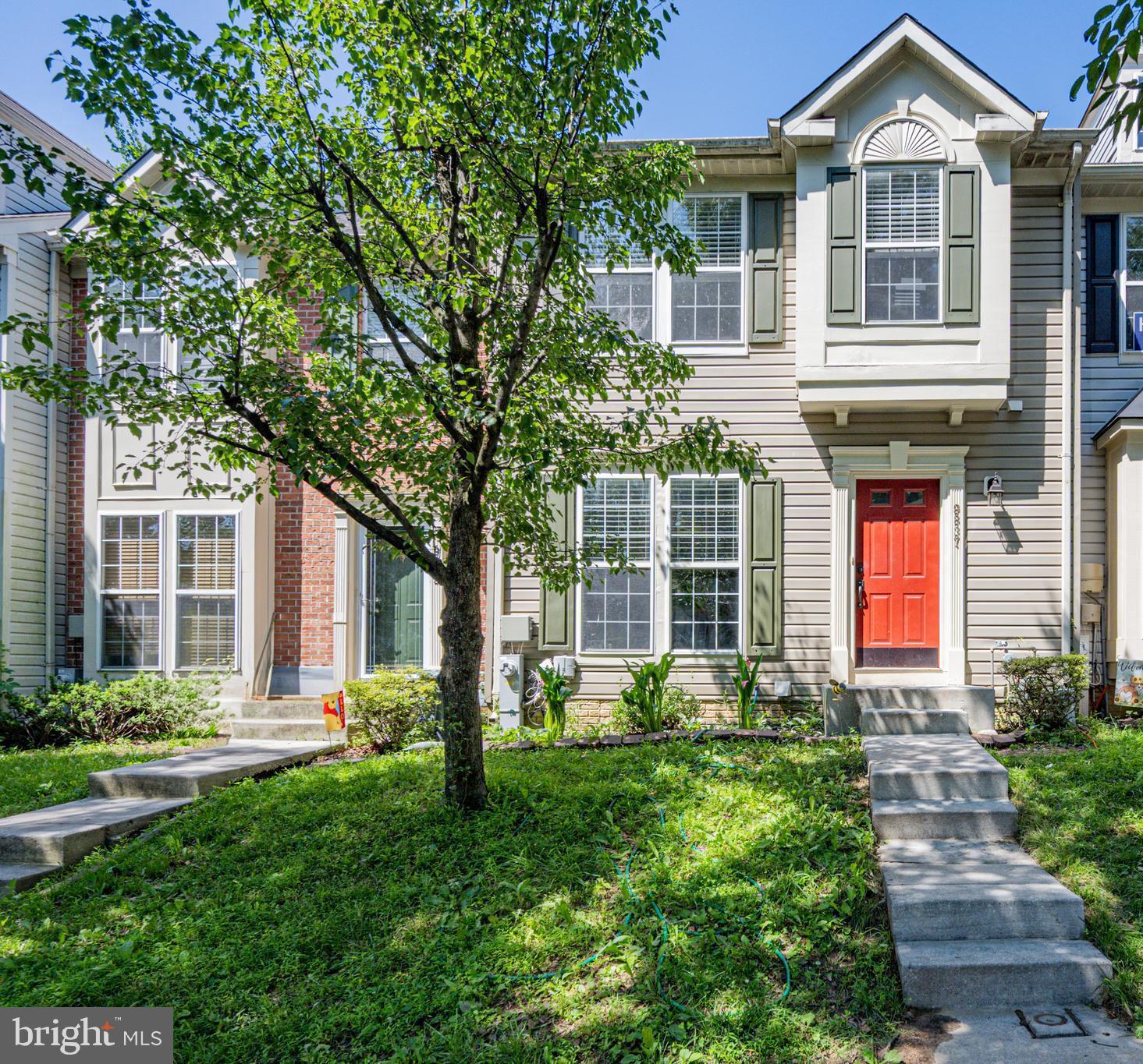 9837 Sherwood Farm Road Owings Mills, MD 21117 - Photo 3 of 35 a front view of a house with a yard and glass windows