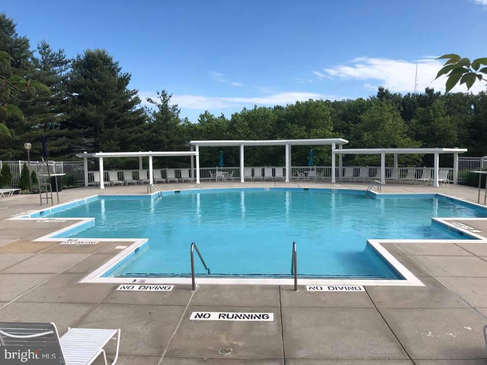 9837 Sherwood Farm Road Owings Mills, MD 21117 - Photo 34 of 35 a view of a swimming pool with a yard