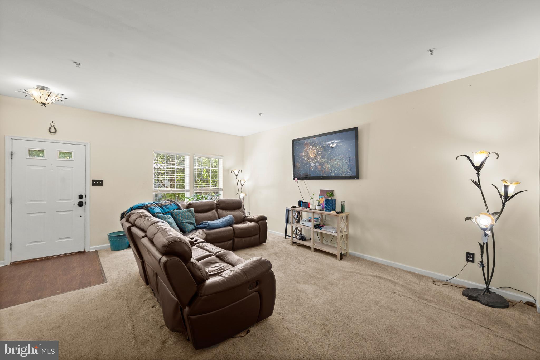 9837 Sherwood Farm Road Owings Mills, MD 21117 - Photo 5 of 35 a living room with furniture a window and a potted plant