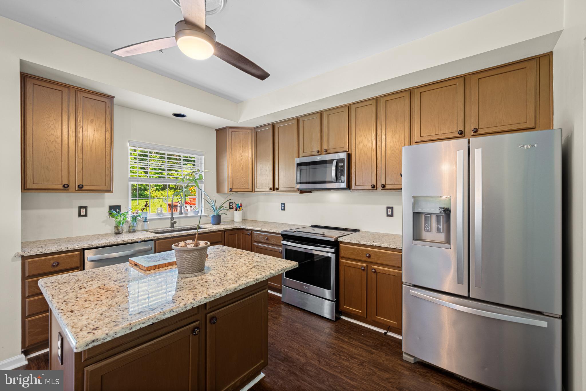 9837 Sherwood Farm Road Owings Mills, MD 21117 - Photo 10 of 35 a kitchen with kitchen island granite countertop a sink appliances cabinets and counter space