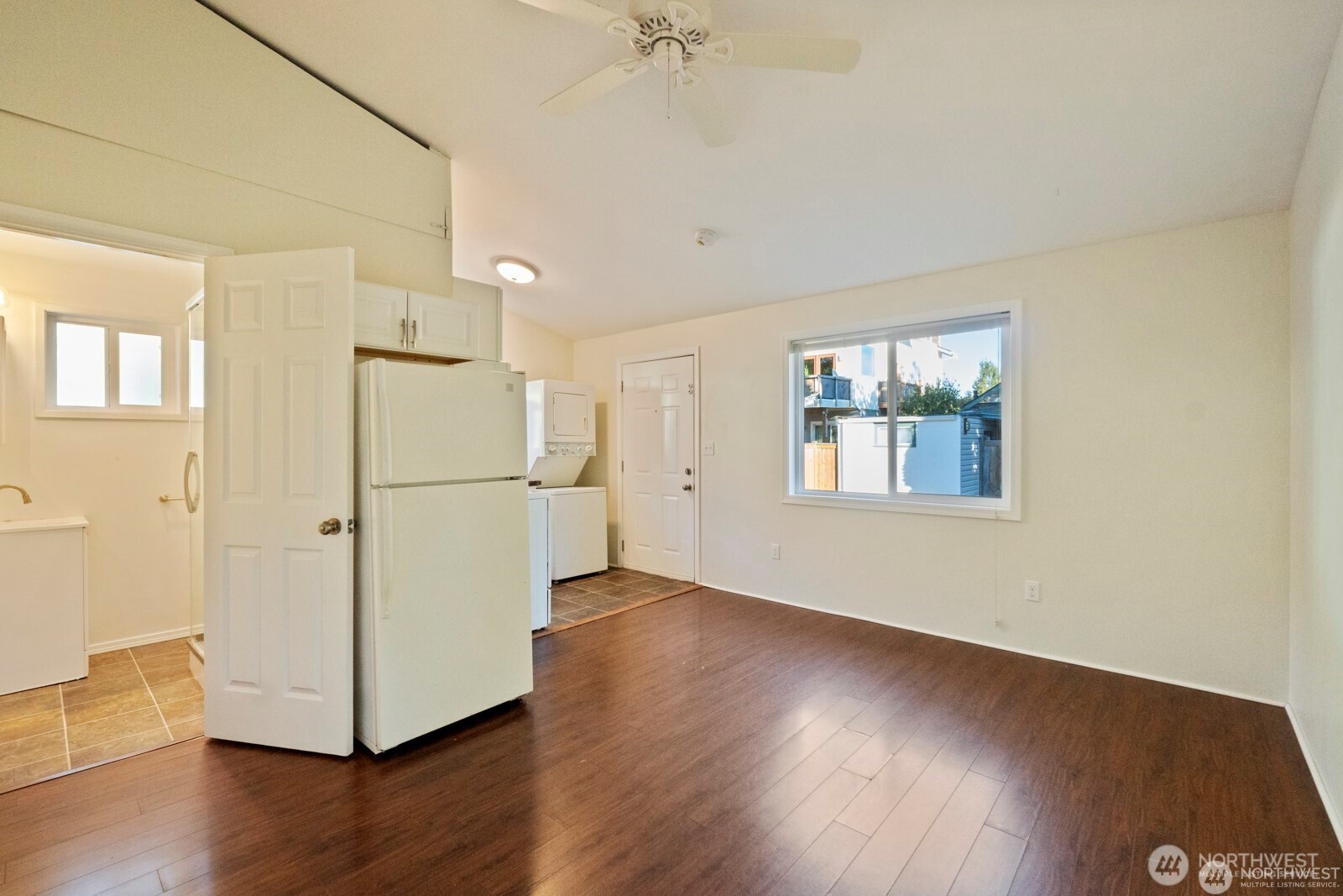120 North 80th Street Seattle, WA 98103 - Photo 11 of 39 a view of a kitchen with wooden floor a ceiling fan and windows