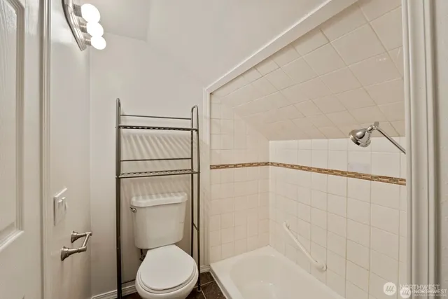 a bathroom with a shower and a toilet