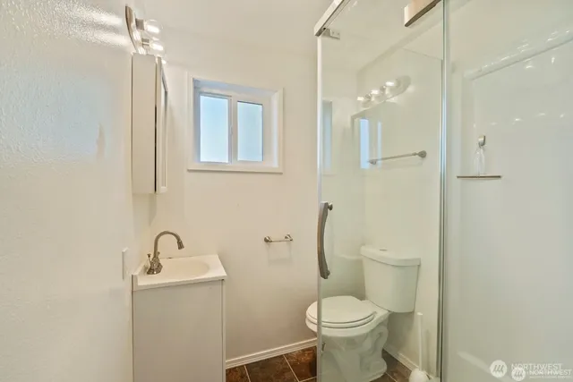 a bathroom with a toilet sink and shower