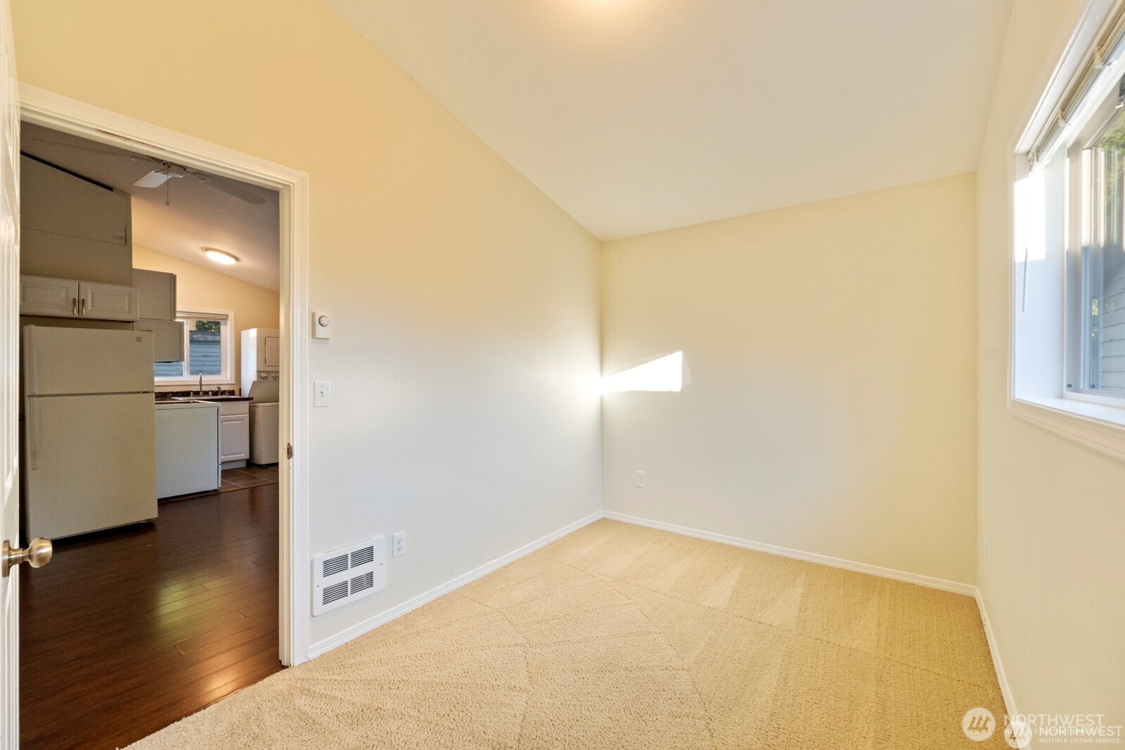 120 North 80th Street Seattle, WA 98103 - Photo 24 of 39 a view of empty room with wooden floor and windows