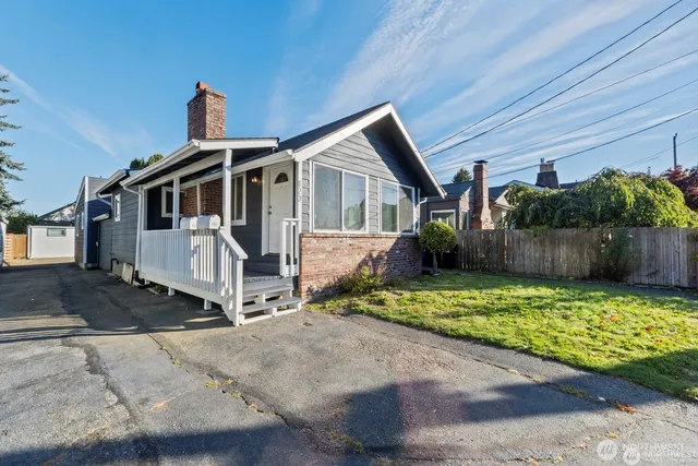 a front view of a house with a yard garage and outdoor seating