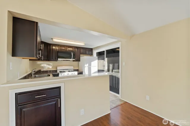a kitchen with stainless steel appliances granite countertop a stove and a sink