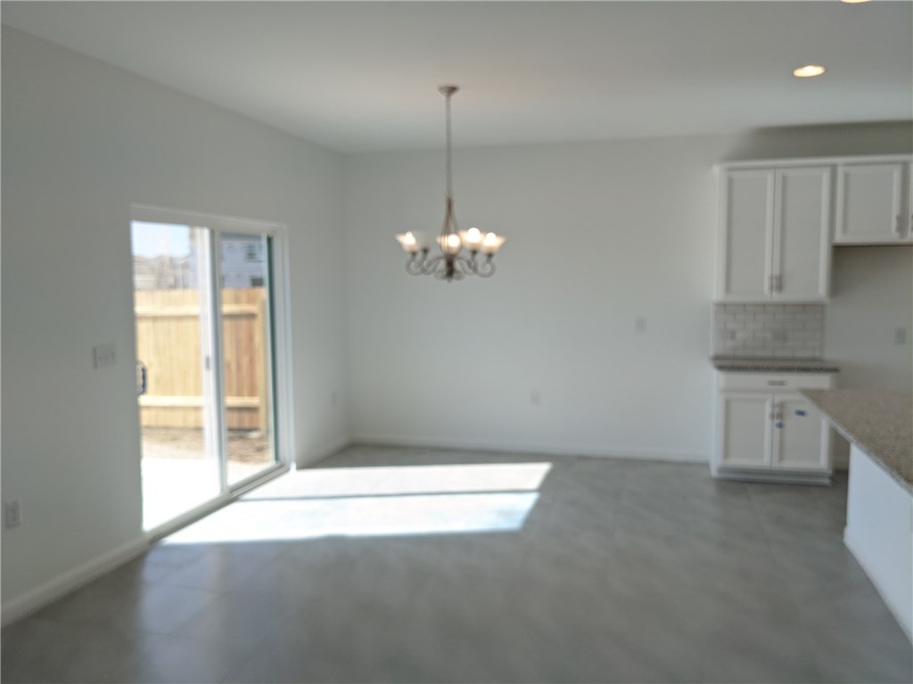 6705 Routenburn Street Austin, TX 78754 - Photo 6 of 18 a view of a kitchen with a dishwasher cabinets and a wooden floor