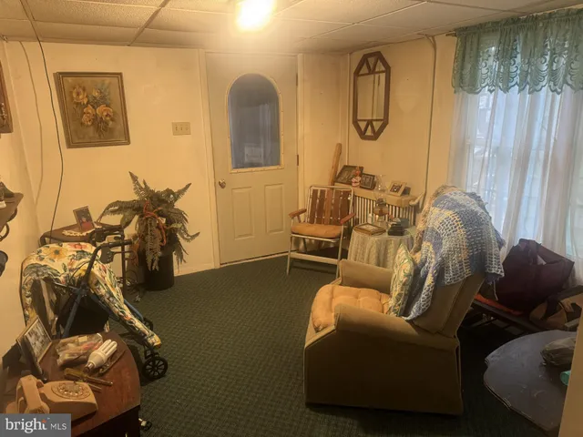 a living room with furniture a window and gym equipment