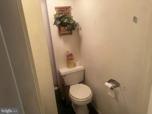 a white toilet sitting next to a sink