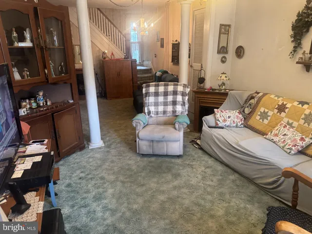 a living room with furniture and a chandelier