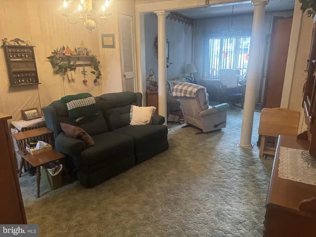 a living room with furniture and a lamp