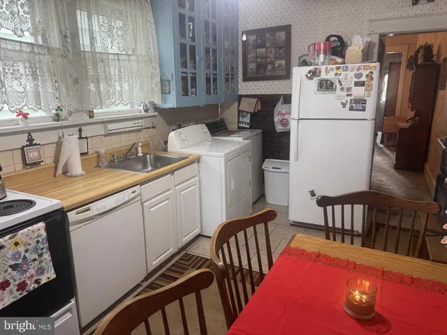 a kitchen with sink refrigerator and cabinets