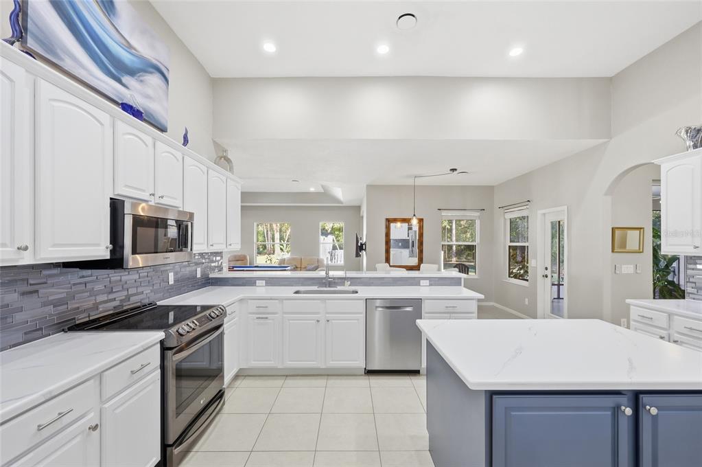 4060 South Kenvera Loop Inverness, FL 34450 - Photo 22 of 50 a kitchen with a sink stove cabinets and refrigerator