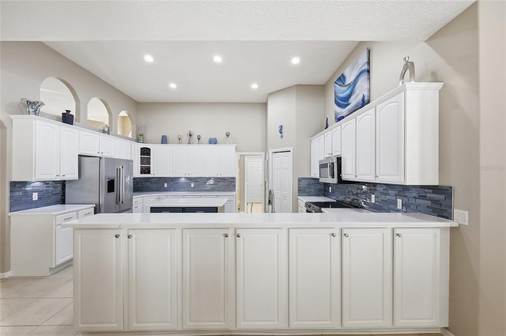 4060 South Kenvera Loop Inverness, FL 34450 - Photo 26 of 50 a kitchen with stainless steel appliances kitchen island granite countertop a sink and cabinets