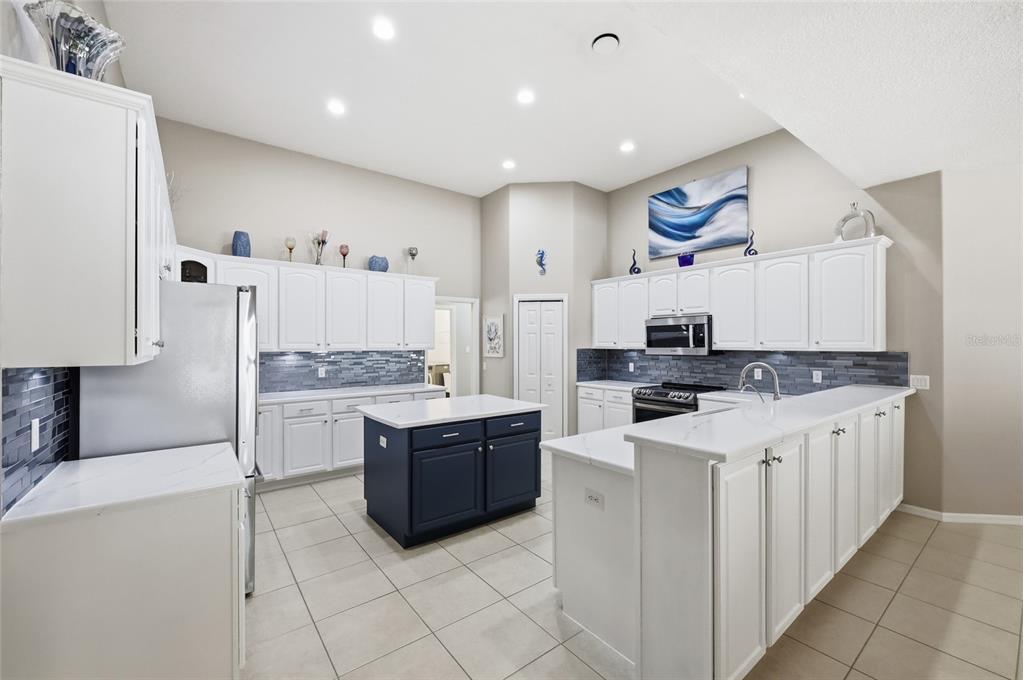 4060 South Kenvera Loop Inverness, FL 34450 - Photo 27 of 50 a kitchen with kitchen island cabinets and refrigerator