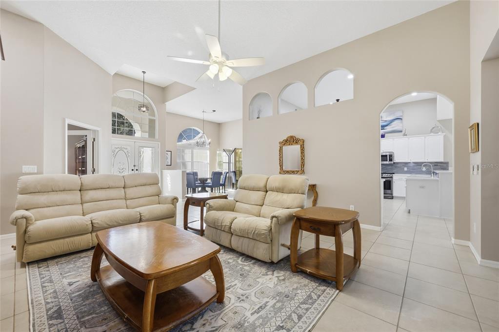 4060 South Kenvera Loop Inverness, FL 34450 - Photo 29 of 50 a living room with furniture a fireplace and a chandelier