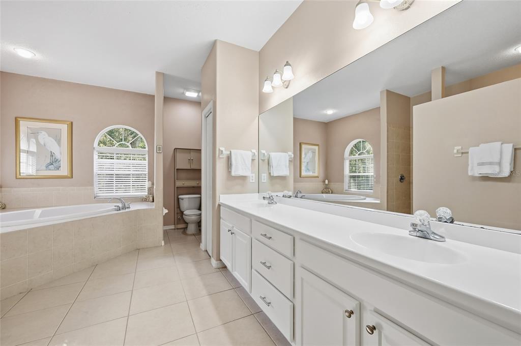4060 South Kenvera Loop Inverness, FL 34450 - Photo 36 of 50 a spacious bathroom with a granite countertop double vanity sink a mirror and a bathtub