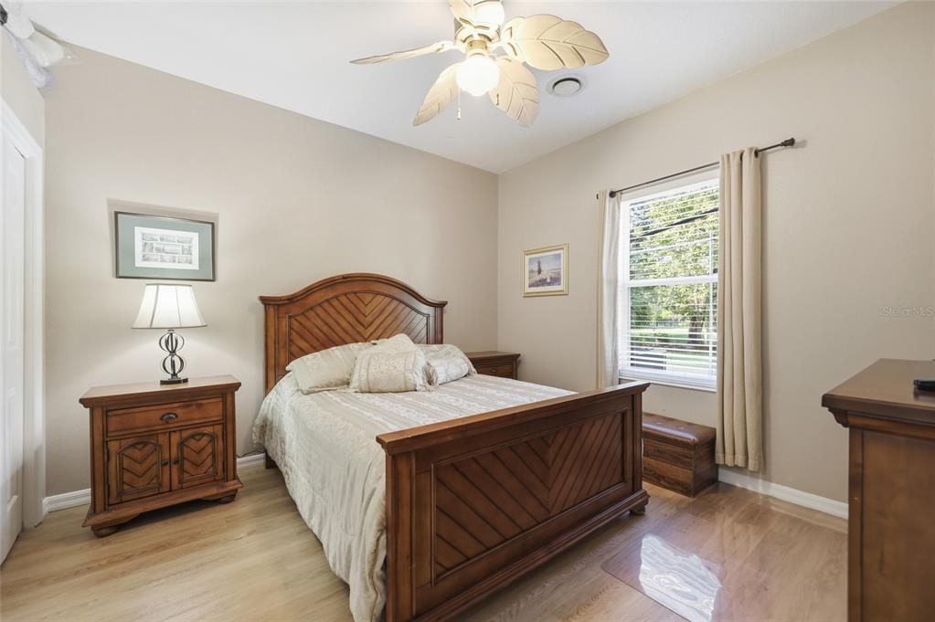 4060 South Kenvera Loop Inverness, FL 34450 - Photo 40 of 50 a bedroom with a bed a chandelier and a window